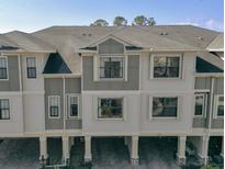 Stylish townhome with neutral exterior, covered parking, and well-maintained landscaping at 9705 Bay Grove Ln, Tampa, FL 33615