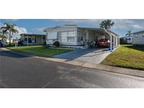 Charming single-story home features a carport, well-maintained lawn, and a welcoming facade at 13225 101St St # 462, Largo, FL 33773