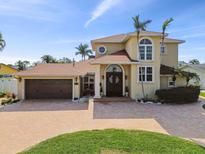 Stunning two-story home featuring a brick driveway, large front door, and lush landscaping at 1336 51St Ne Ave, St Petersburg, FL 33703
