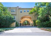 Mediterranean-style building with a grand archway and gated entrance, set amidst lush greenery at 3010 W Stovall St # B, Tampa, FL 33629