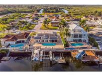 Waterfront home featuring a private pool, boat dock, and picturesque canal views at 3939 Rudder Way, New Port Richey, FL 34652