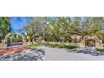 View of the Vista Del Mar gated entrance and manicured lawns from across the street at 5020 S Shore Crest Cir, Tampa, FL 33609