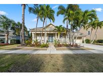 Charming single-story home with lush landscaping, a welcoming front porch, and a beautifully paved walkway at 5229 Brighton Shore Dr, Apollo Beach, FL 33572