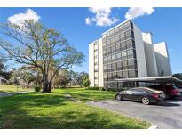 Well-maintained condo building with covered parking and lush green space at 2900 Cove Cay Dr # 4A, Clearwater, FL 33760