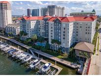Stunning aerial view of waterfront condos, docks, and a sparkling community pool surrounded by lush landscaping at 700 S Harbour Island Blvd # 738, Tampa, FL 33602