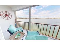 Relaxing balcony with comfortable seating and stunning waterfront views at 7910 Sun Island S Dr # 305, South Pasadena, FL 33707