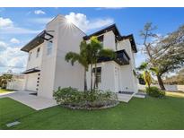Modern home with black trim, white walls, and a well-manicured front yard at 902 W Sligh Ave, Tampa, FL 33604