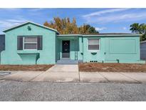 A charming single-story home showcasing a unique teal exterior and inviting front entrance at 2169 22Nd N Ave, St Petersburg, FL 33713