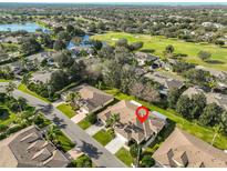 Expansive aerial view showcases home's prime location near golf course and serene lake at 1912 Acadia Greens Dr, Sun City Center, FL 33573