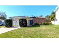 Charming single-story home featuring a well-maintained lawn and a convenient carport at 602 Danube Ave, Tampa, FL 33606