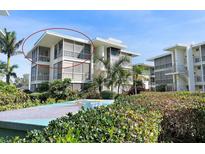 A condo building features a modern design and lush tropical landscaping at 1036 N Shore Ne Dr # 5, St Petersburg, FL 33701