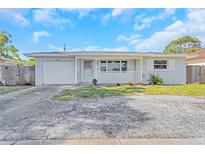 Charming single-story home with a well-maintained front yard and attached garage at 1140 7Th Ne Ave, Largo, FL 33770