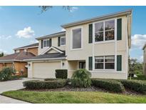 Two-story home with a well-maintained lawn, lush shrubbery and attached two car garage and large windows at 20115 Nob Oak Ave, Tampa, FL 33647