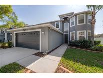 Charming two-story home featuring a well-maintained lawn, attached two-car garage, and a welcoming entryway at 3025 Chessington Dr, Land O Lakes, FL 34638