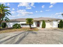 Charming single story home with mature landscaping and a spacious driveway at 1730 Sunset Point Rd, Clearwater, FL 33755