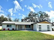 Charming single-story home boasts fresh white paint, modern garage door and well-manicured lawn at 3735 69Th N Way, St Petersburg, FL 33710
