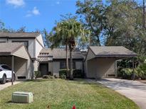 Charming one-story home featuring neutral paint, lush landscaping, and carport providing covered parking at 375 Woods Landing Trl, Oldsmar, FL 34677