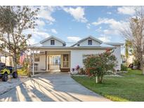 Charming single-Gathering home with a covered carport, lush lawn, and a beautifully landscaped front yard at 607 Manatee Ave, Ellenton, FL 34222