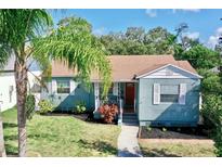 Charming single-story home with a well-manicured lawn and inviting, red front door at 1011 W Charter St, Tampa, FL 33602