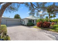 Lovely home with a two-car garage, attractive landscaping, and a welcoming entrance at 10351 Longwood Dr, Seminole, FL 33777