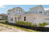 Charming townhome features a two-car garage and neutral color scheme with well maintained landscaping at 31857 Anchor Point Dr, Wesley Chapel, FL 33545