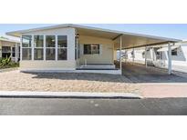 Charming home with a covered carport and gravel landscaping for low maintenance appeal at 37838 Granada Ave, Zephyrhills, FL 33541