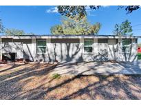 Charming single story home with a well-maintained lawn and mature trees in a tranquil neighborhood at 39809 Pretty Pond Rd, Zephyrhills, FL 33540