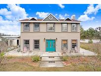 Two-story home featuring a blue front door and symmetrical window placement at 11050 Revell Rd, Duette, FL 34219