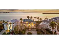 Stunning waterfront home with meticulous landscaping and charming curb appeal in a desirable neighborhood with views of the sea at 2077 N Pointe Alexis Dr, Tarpon Springs, FL 34689