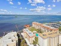 Beautiful condo community with pool, marina, dock, and stunning water views on a sunny day at 620 Edgewater Dr # 204, Dunedin, FL 34698