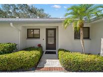 Charming villa front entrance, with lush landscaping, accentuating a welcoming appeal and curb appeal at 2757 Countryside Blvd # 103, Clearwater, FL 33761