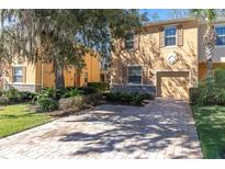 Charming home with a brick driveway and well-maintained landscaping at 13946 Snapper Fin Ln, Tampa, FL 33637