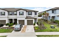 Well maintained townhome with a one-car garage and driveway parking at 36419 Garden Wall Way, Zephyrhills, FL 33541