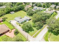 Expansive home with a lush green lawn, mature trees, and a long private driveway at 1700 S Miller Rd, Valrico, FL 33594