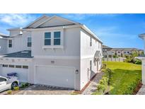 Charming two-story townhouse featuring an attached garage and manicured landscaping in a desirable community at 31869 Anchor Point Dr, Wesley Chapel, FL 33545
