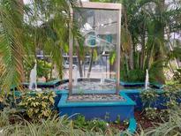 Unique property fountain with stone basin and modern design surrounded by tropical landscaping and palm trees at 470 3Rd S St # 416, St Petersburg, FL 33701