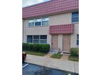 Two-story building featuring symmetrical windows, covered entryways, and well-maintained landscaping at 10033 64Th N Ave # 9, St Petersburg, FL 33708