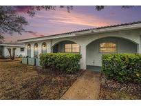 Charming home exterior with an arched entryway, fresh landscaping, and a beautiful sunset view at 11200 102Nd Ave # 16, Seminole, FL 33778