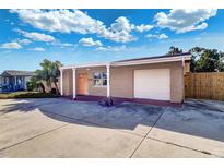 Charming single-story home featuring a well-maintained lawn, driveway, and an attached garage at 3048 Holiday Lake Dr, Holiday, FL 34691
