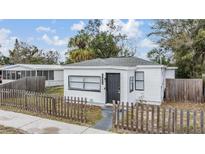 Charming home featuring a well-maintained front yard with a classic picket fence, new roof, and freshly painted exterior at 3620 E Shadowlawn Ave, Tampa, FL 33610