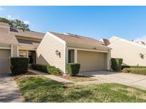 Charming townhome with a one-car garage and well-maintained landscaping at 3130 Eagles Landing W Cir, Clearwater, FL 33761