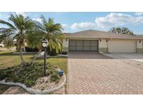 Charming single-story home featuring a brick driveway and well-manicured front yard at 335 Stroll Ln, Sun City Center, FL 33573