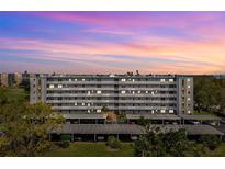 Stunning view of the multi-story condo building featuring covered parking and well-manicured landscaping at 4240 Ironwood Cir # 404, Bradenton, FL 34209
