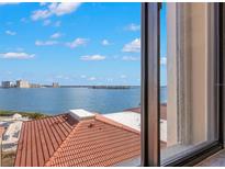 Scenic water view with a tile roof and clear blue skies from an expansive window at 6322 Palma Del Mar S Blvd # 506, St Petersburg, FL 33715