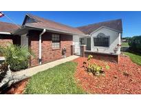 Charming single story home showcasing a manicured lawn and brick accents at 6504 Brentwood Dr, Zephyrhills, FL 33542