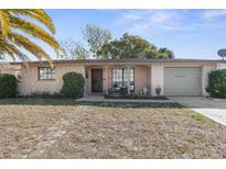 Charming single-story home with a well-manicured front yard and attached garage at 6840 Mesa Verde St, Port Richey, FL 34668