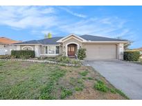 Charming single-story home featuring a well-manicured lawn and inviting curb appeal at 1559 Overland Dr, Spring Hill, FL 34608