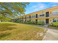 Inviting condo exterior boasting well-manicured lawn and a classic two-story facade at 2501 Harn Blvd # H34, Clearwater, FL 33764