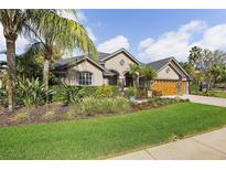 Charming home with well-maintained lawn and tropical landscaping, offering great curb appeal at 2981 Northfield Dr, Tarpon Springs, FL 34688