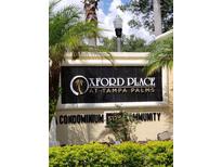 Oxford Place at Tampa Palms condominium community sign with lush landscaping at 5125 Palm Springs Blvd # 1101, Tampa, FL 33647